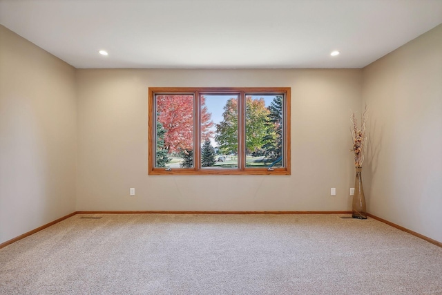 carpeted spare room featuring recessed lighting and baseboards