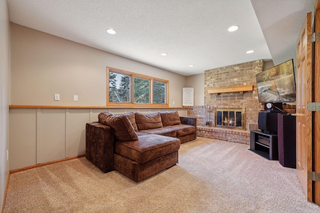 living area featuring recessed lighting, carpet floors, a textured ceiling, and a brick fireplace