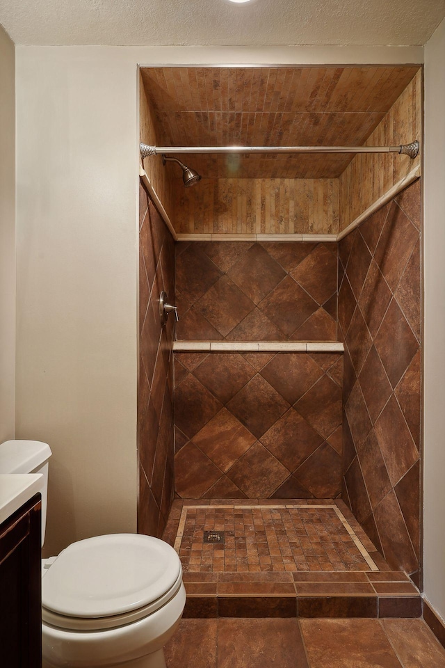 full bath with vanity, a shower stall, and toilet