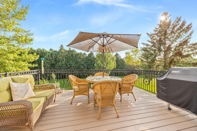 deck with area for grilling and outdoor dining space