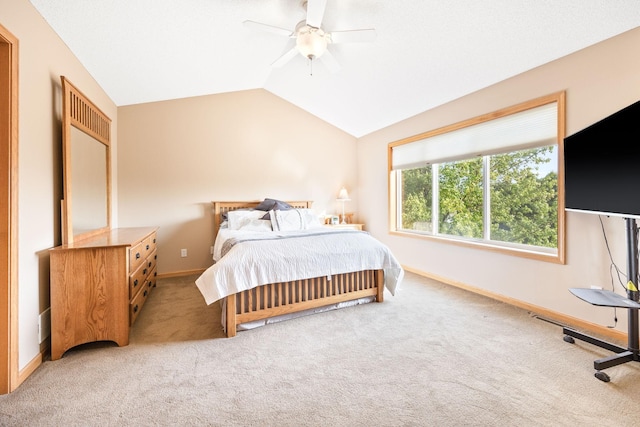 bedroom featuring baseboards, lofted ceiling, and light colored carpet