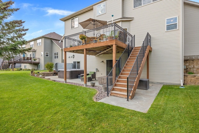 rear view of house featuring a lawn, a hot tub, a wooden deck, stairs, and a patio area