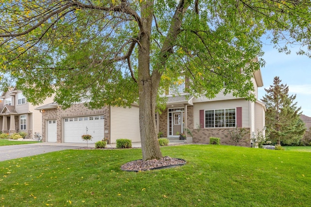 view of front of house with a front lawn, brick siding, a garage, and driveway