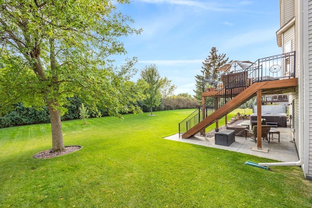 view of yard with a wooden deck, stairs, and a patio area