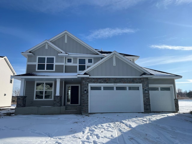 craftsman house featuring a garage, stone siding, board and batten siding, and a porch