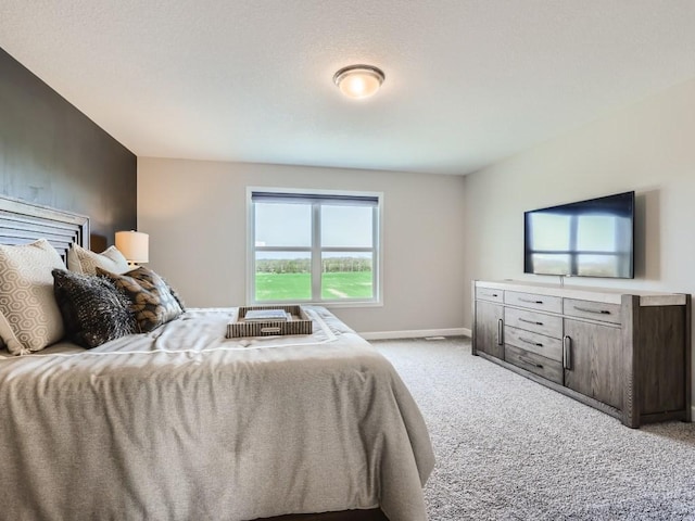 bedroom featuring light colored carpet and baseboards