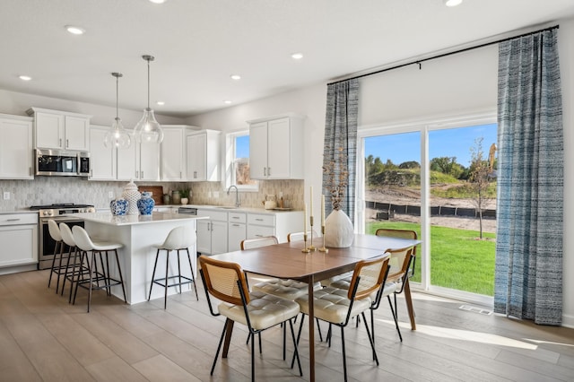 dining area with recessed lighting, visible vents, and light wood-style floors