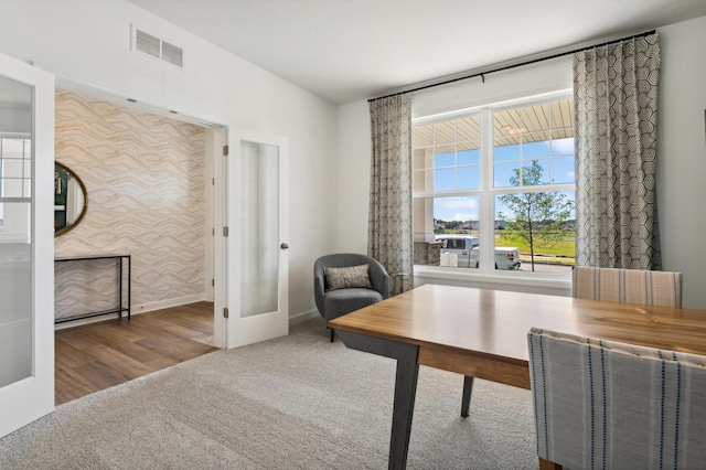 carpeted office space with french doors, visible vents, and baseboards