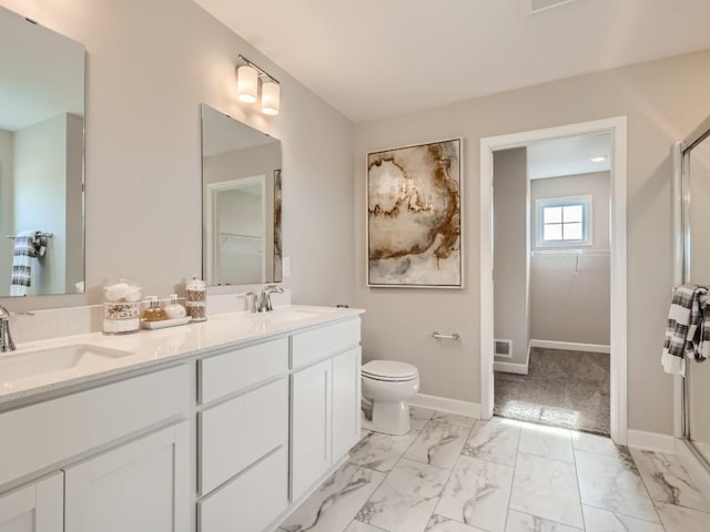 full bath with a sink, marble finish floor, and a shower stall