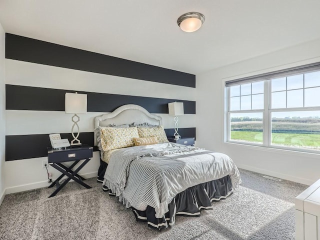 bedroom featuring visible vents, baseboards, and carpet