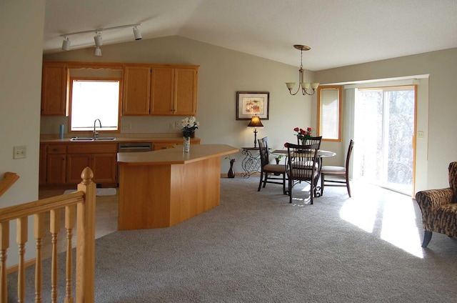 kitchen featuring lofted ceiling, a sink, light countertops, dishwasher, and light colored carpet