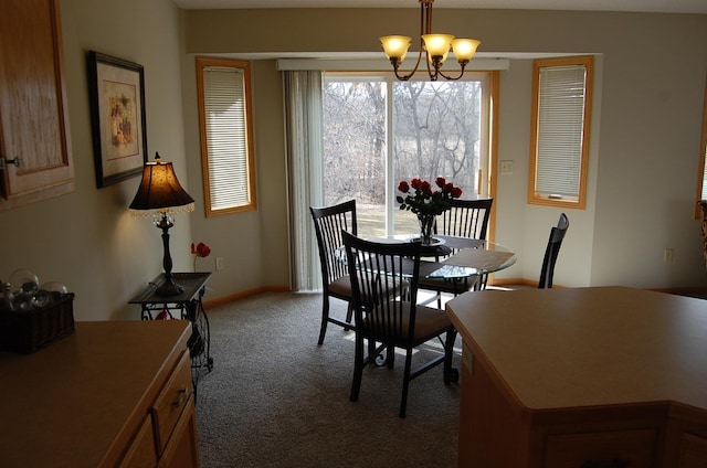 dining area featuring baseboards, carpet floors, and a chandelier