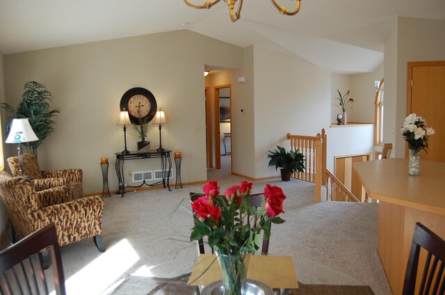 interior space featuring vaulted ceiling, baseboards, and visible vents