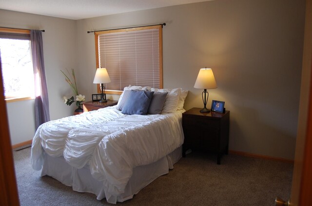 carpeted bedroom featuring baseboards