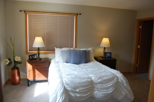 bedroom with carpet flooring and baseboards