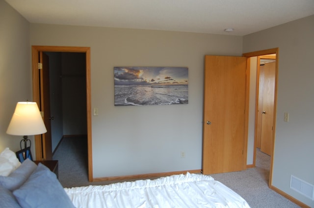 carpeted bedroom featuring visible vents and baseboards