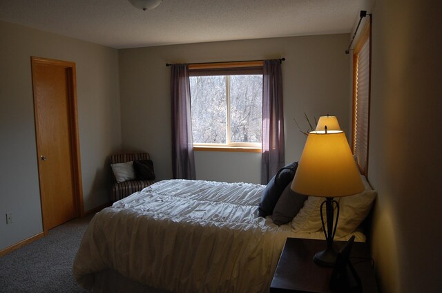 carpeted bedroom with baseboards