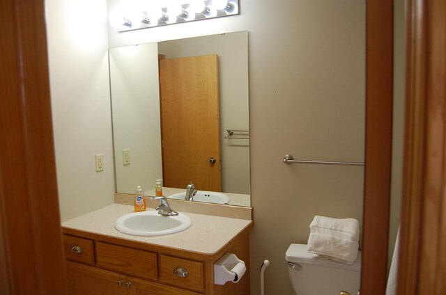 bathroom with toilet and vanity