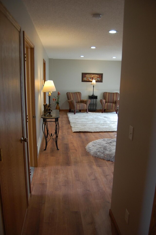 hall with recessed lighting and wood finished floors