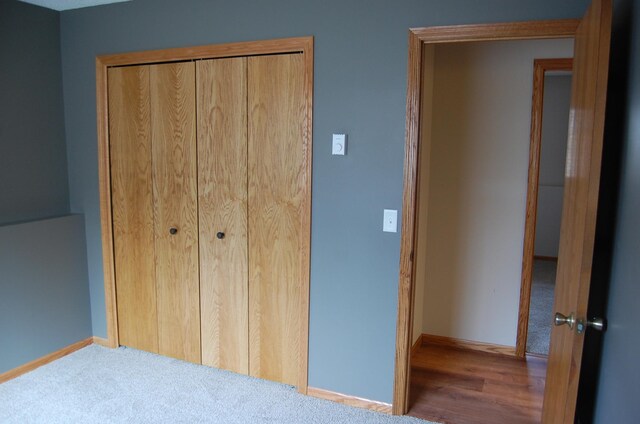 unfurnished bedroom with a closet and baseboards