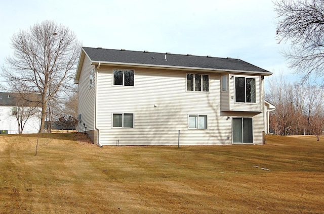 back of property featuring a lawn