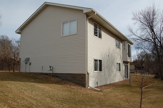 view of side of home featuring a lawn