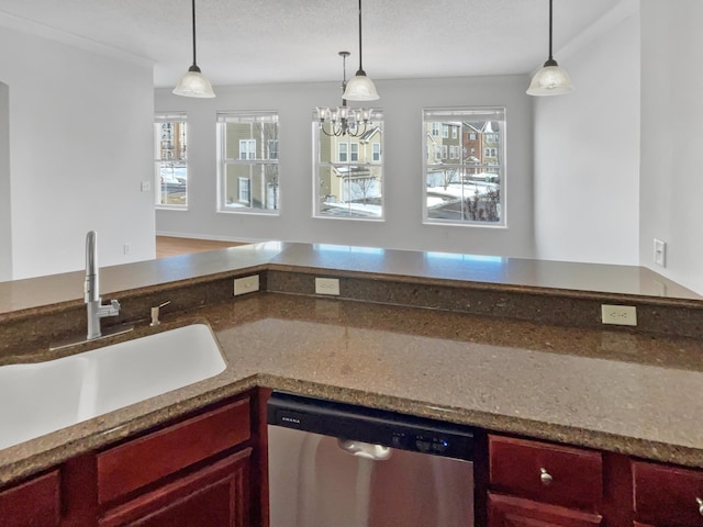 kitchen featuring dark brown cabinets, dishwasher, pendant lighting, and a sink