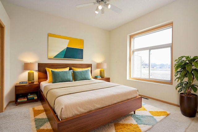 bedroom with ceiling fan, baseboards, and carpet floors