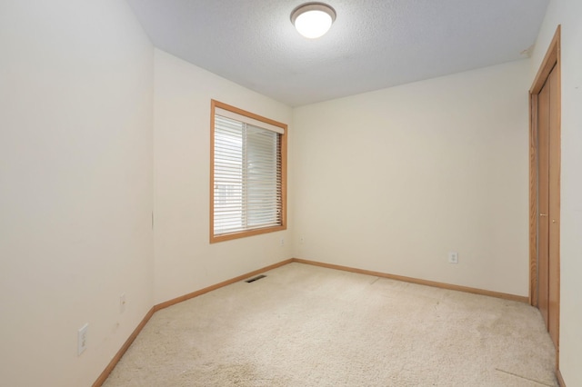 unfurnished bedroom with light colored carpet, visible vents, and baseboards