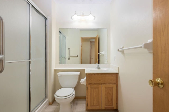 bathroom with tile patterned floors, a shower stall, toilet, and vanity