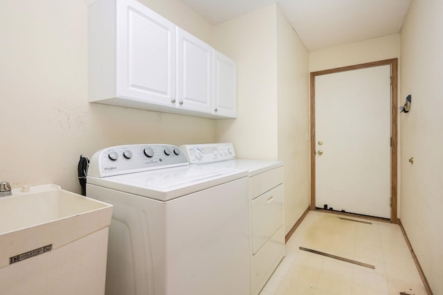 clothes washing area with light floors, baseboards, cabinet space, a sink, and washer and dryer