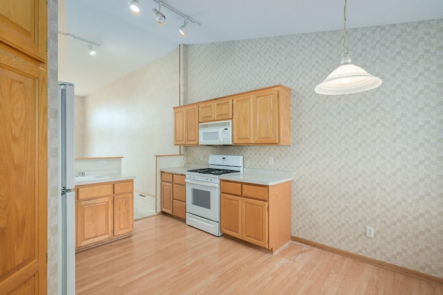 kitchen featuring wallpapered walls, white appliances, light countertops, and light wood finished floors