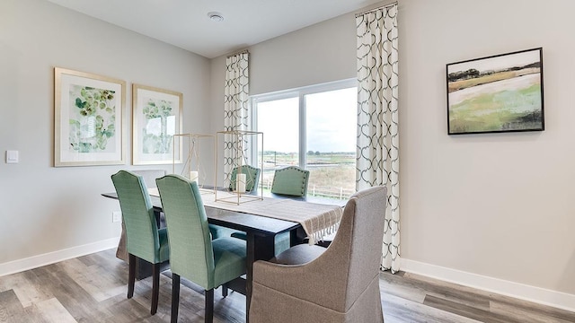 dining area with wood finished floors and baseboards