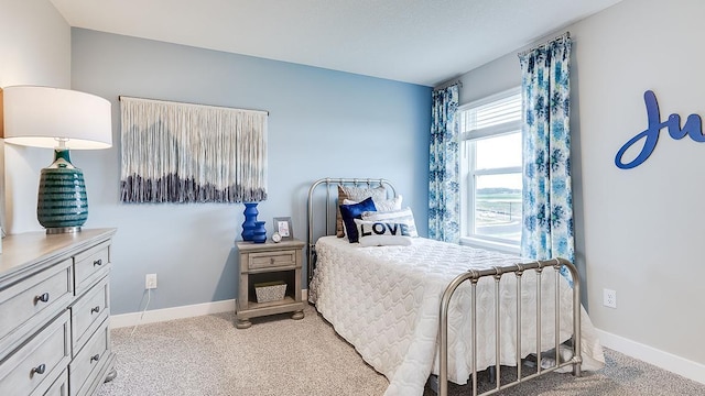 bedroom with baseboards and light carpet