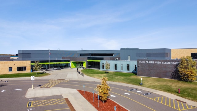 view of building exterior featuring uncovered parking