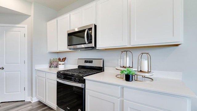 7856 Martin Ave NE, Otsego, MN 55330 - kitchen with appliances with stainless steel finishes, light countertops, and white cabinetry