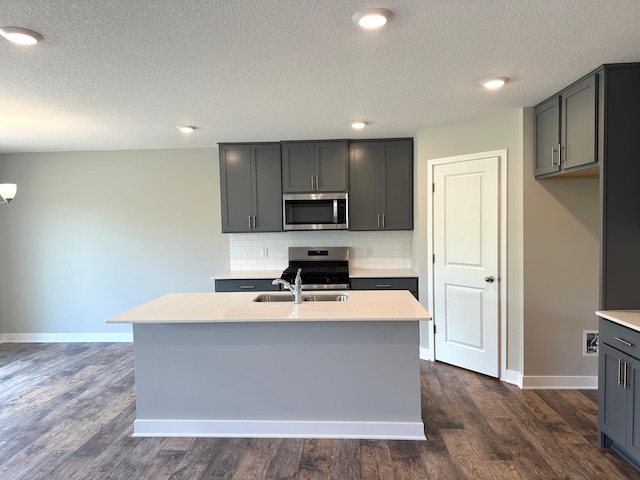 7856 Martin Ave NE, Otsego, MN 55330 - kitchen with appliances with stainless steel finishes, light countertops, decorative backsplash, baseboards, and dark wood-style flooring