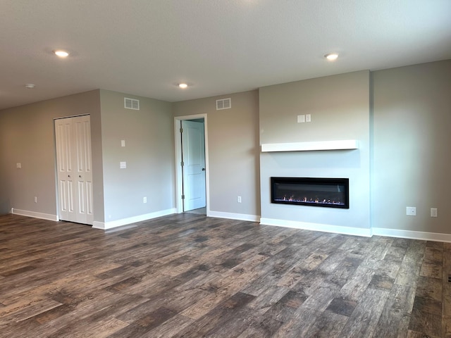 7856 Martin Ave NE, Otsego, MN 55330 - unfurnished living room with dark wood-type flooring, baseboards, recessed lighting, and a glass covered fireplace