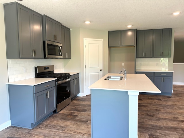 7856 Martin Ave NE, Otsego, MN 55330 - kitchen with stainless steel appliances, dark wood-style flooring, baseboards, a sink, and tasteful backsplash