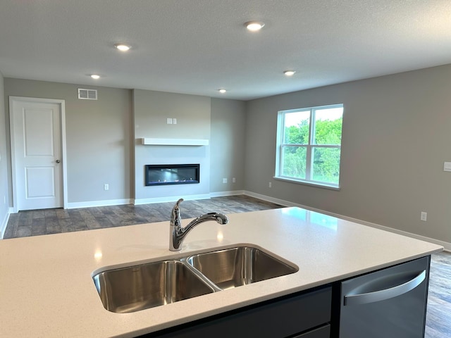 7856 Martin Ave NE, Otsego, MN 55330 - kitchen featuring dishwasher, a sink, dark wood-type flooring, baseboards, and a textured ceiling