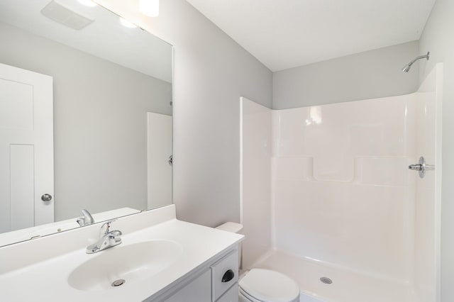 bathroom featuring a shower, visible vents, toilet, and vanity