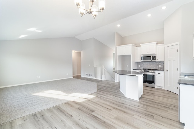 kitchen featuring a notable chandelier, white cabinets, appliances with stainless steel finishes, and a center island