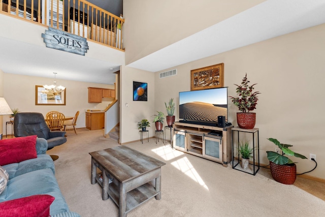 living room featuring stairs, a notable chandelier, light colored carpet, and visible vents