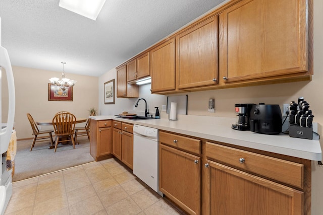 kitchen featuring light colored carpet, pendant lighting, light countertops, white appliances, and a sink