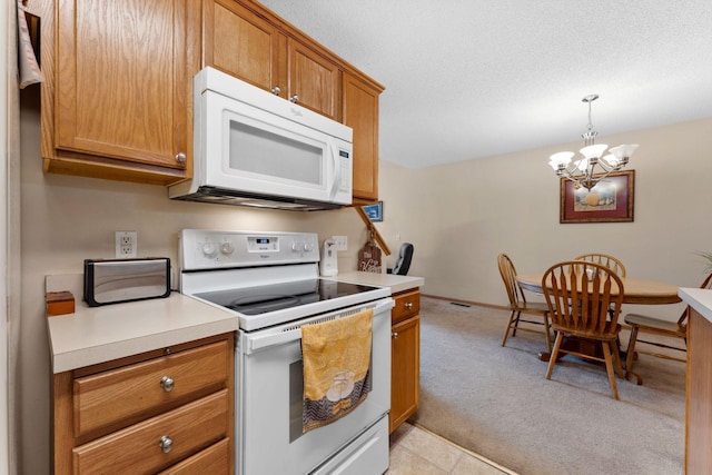 kitchen with white appliances, brown cabinetry, light countertops, pendant lighting, and light carpet