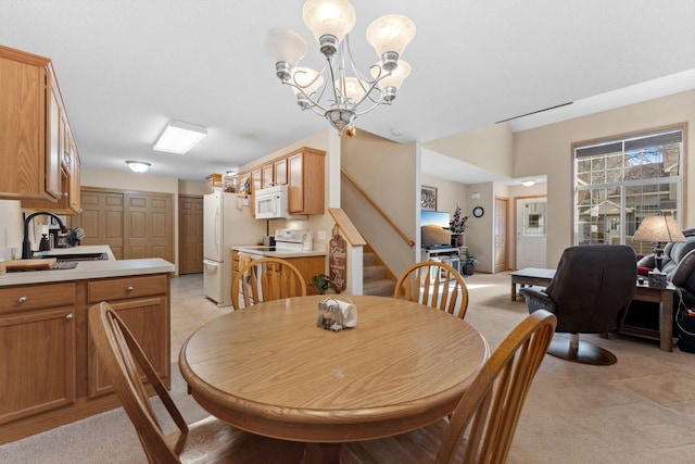 dining room featuring light carpet, stairs, and an inviting chandelier