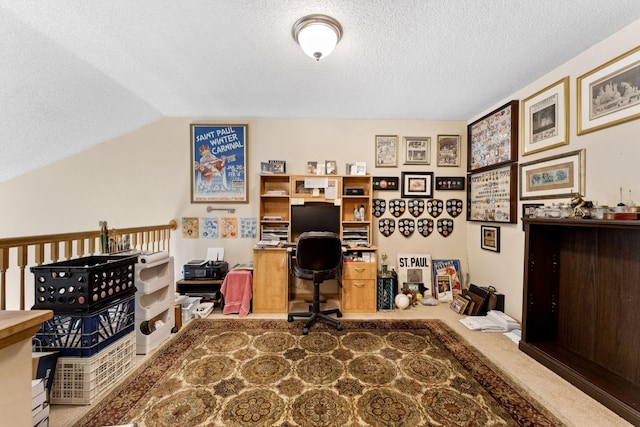 office featuring lofted ceiling, carpet floors, and a textured ceiling