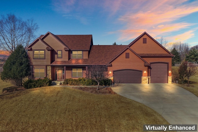 craftsman-style home featuring stone siding, a yard, a garage, and driveway