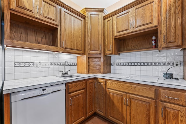 kitchen with open shelves, decorative backsplash, white dishwasher, and a sink