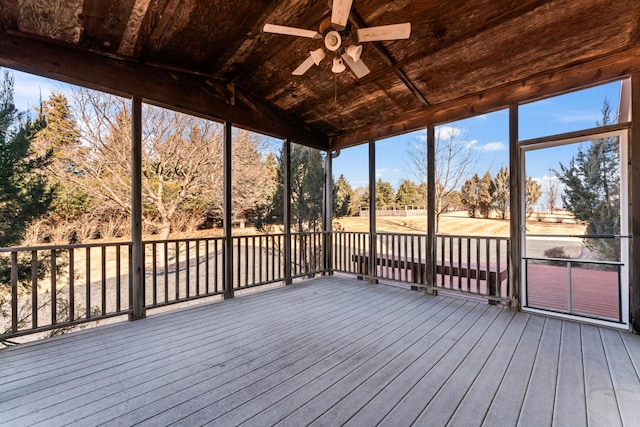 unfurnished sunroom with wood ceiling, lofted ceiling, and a ceiling fan